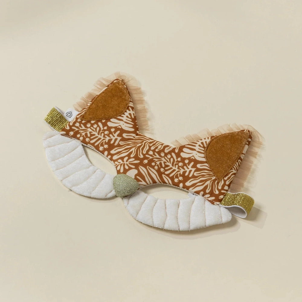 Felt fox toy with patterned body and white paws on a beige background