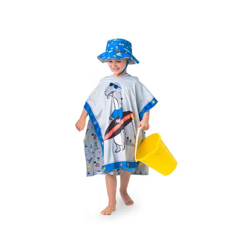 Flapjackkids Cover Up Dino: gray poncho with blue trim and dinosaur print, child walks barefoot with a yellow bucket