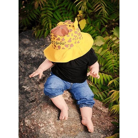 Flapjackkids reversible sun hat for toddlers, yellow with giraffe print, worn by child.
