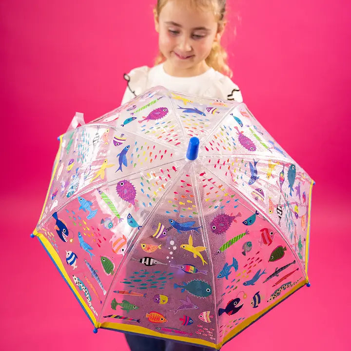 Floss and Rock Transparent Colour Changing Umbrella Ocean; clear canopy shows colorful sea creatures as a girl holds it open.