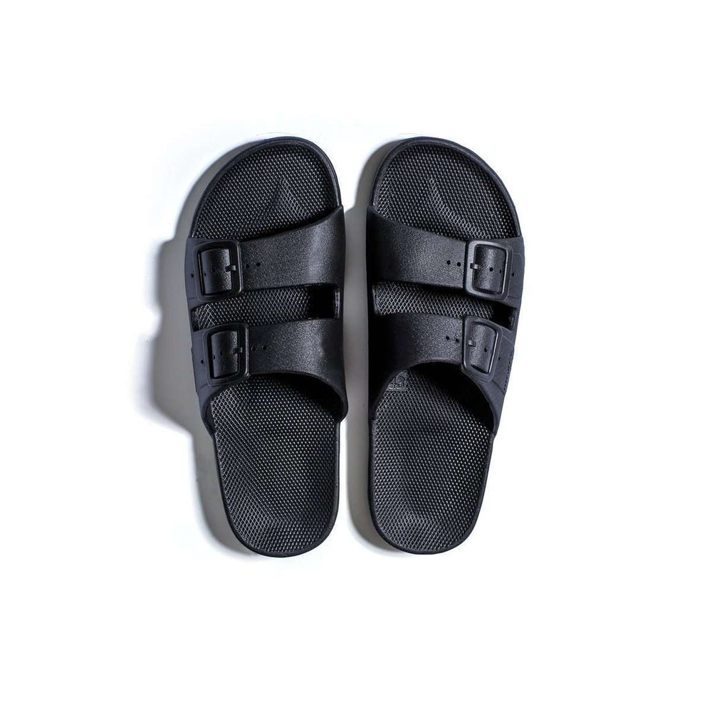 Freedom Moses Basic Black sandals with two buckle straps securely fastened over the footbed on a white background.