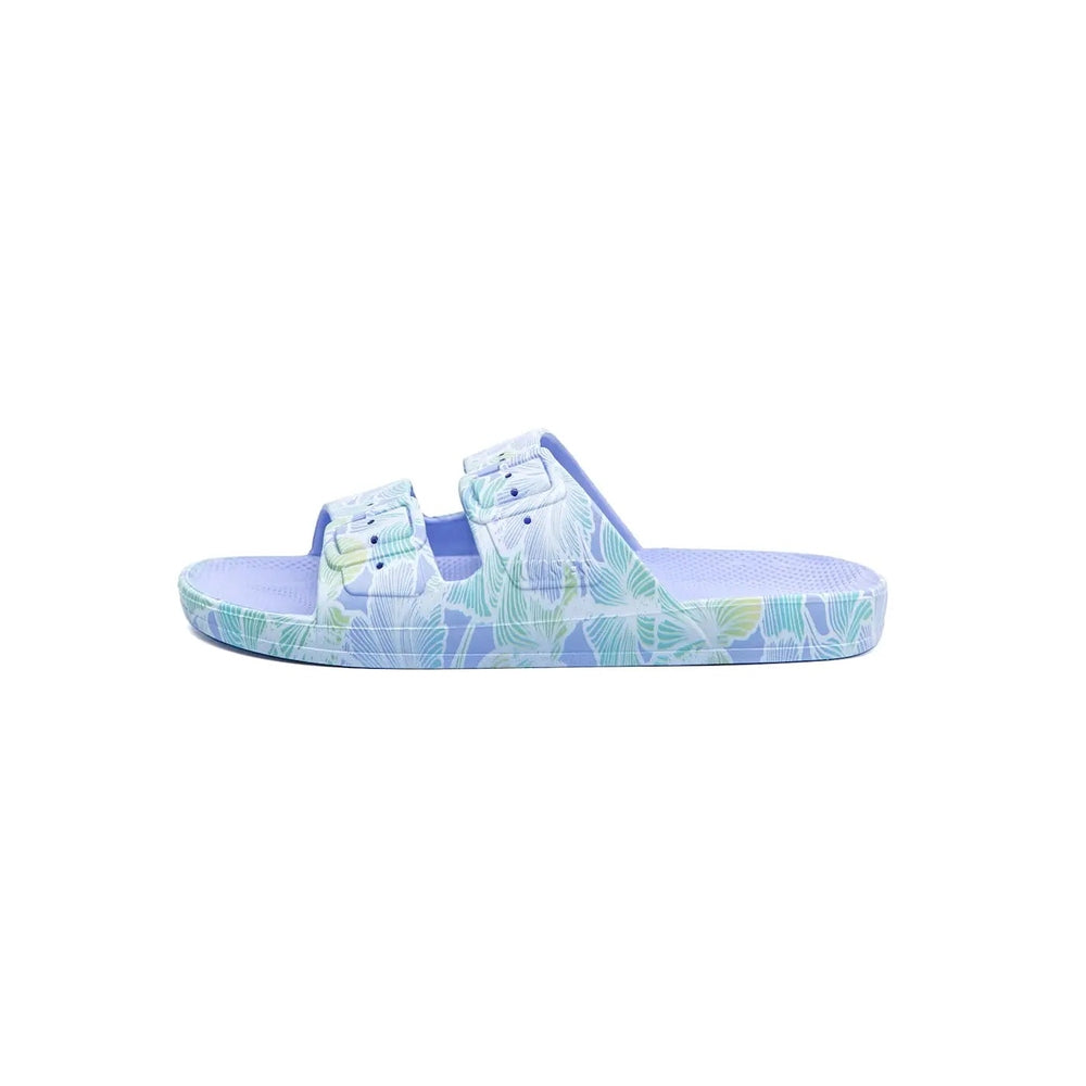 Freedom Moses Prints Adult Aloha Hydra slide sandal in pastel blue tropical print, two straps secured on a textured footbed.