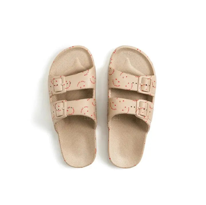 Freedom Moses Prints Adult Love Rules Sands sandals, beige with red print, two buckle straps shown from top.