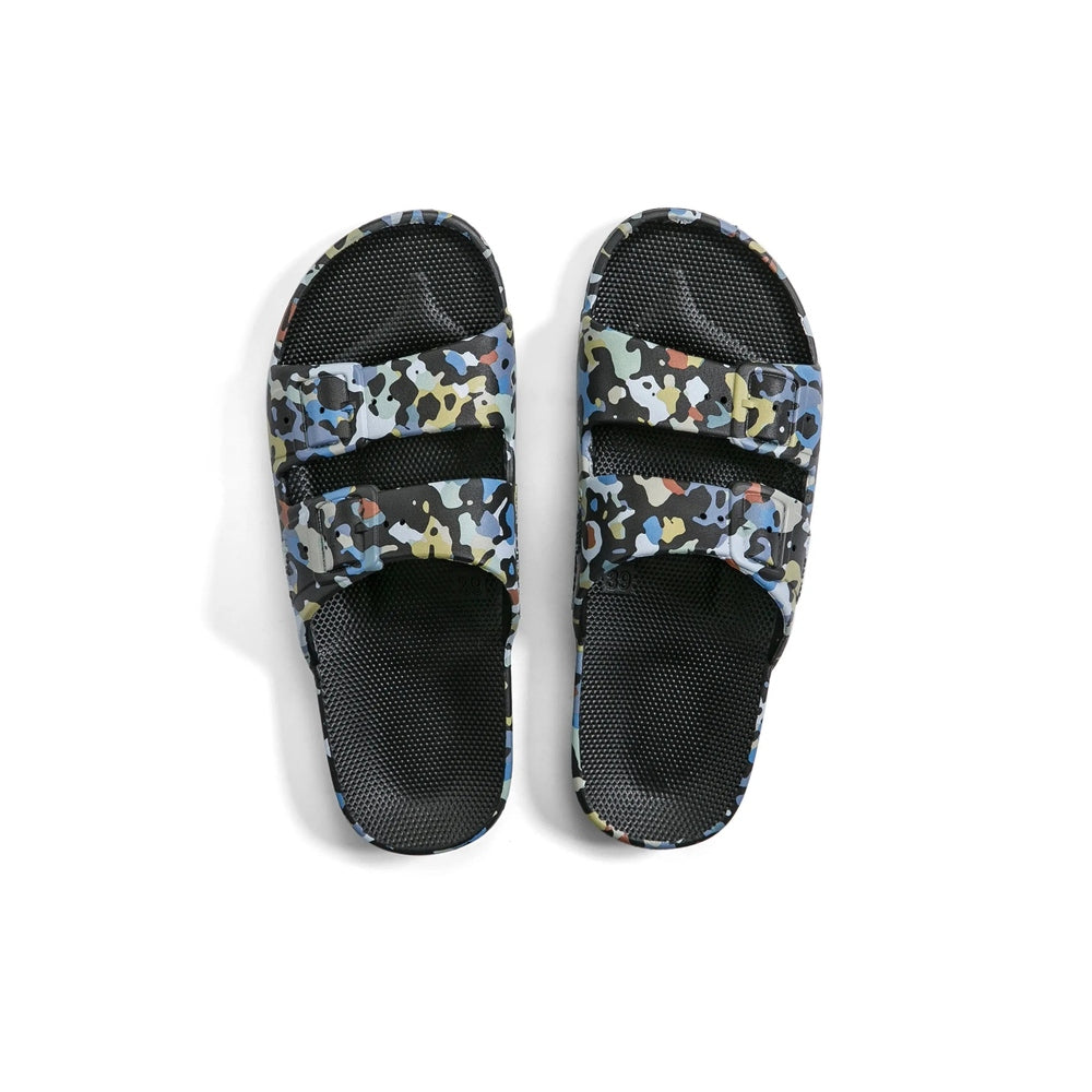 Freedom Moses Prints Adult Mercury Black sandals on white, showing dual camouflage straps and textured black footbeds.