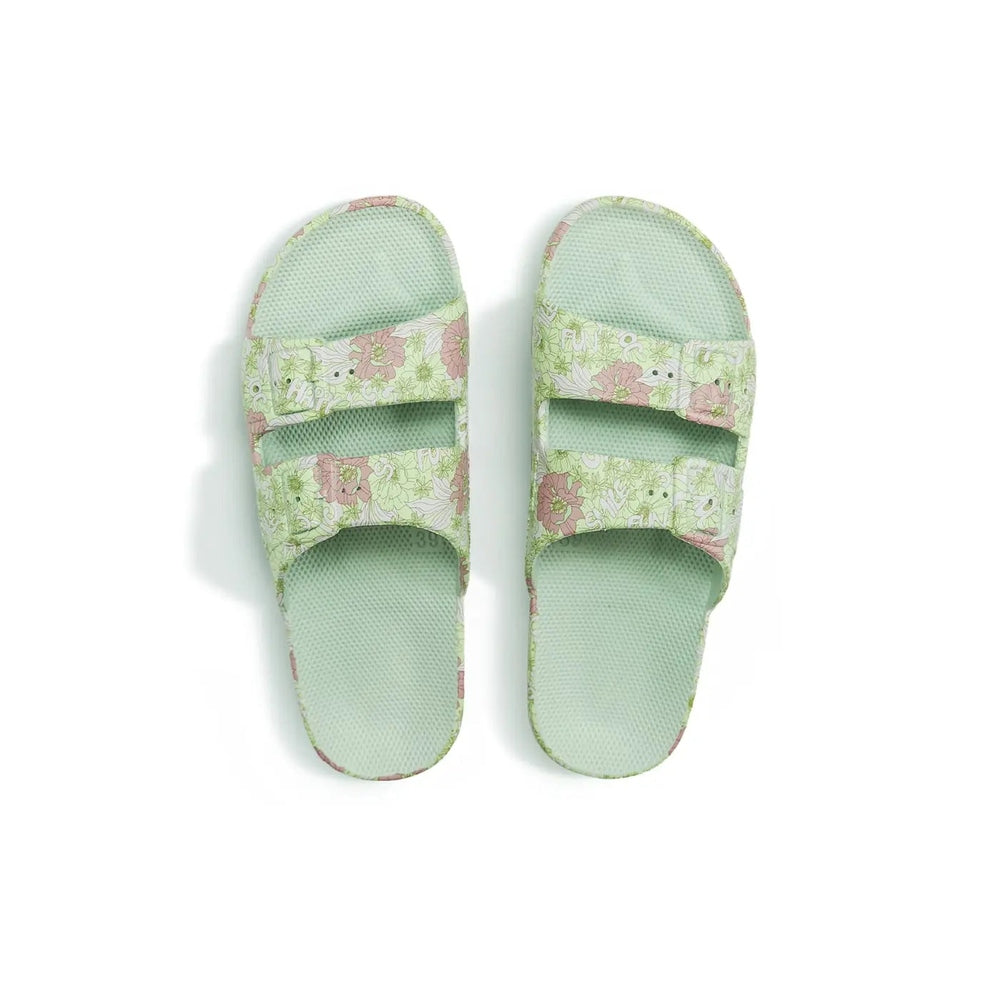 Freedom Moses Prints Adult Smile Sage floral slides with pastel green straps, two sandals laid flat.