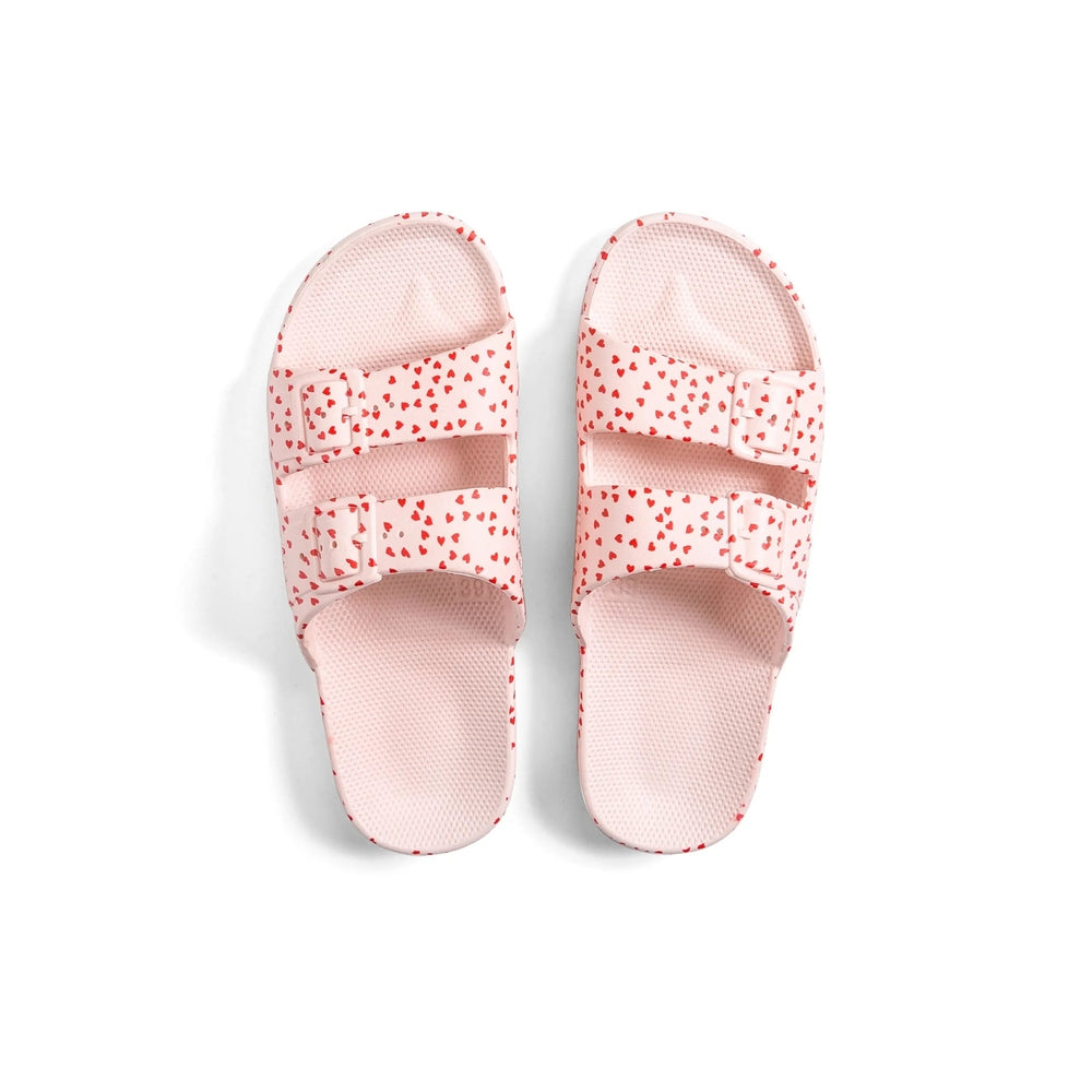 Freedom Moses Prints Love 2.0 Rosa kids' pink heart-print slide sandals, two-strap pair.