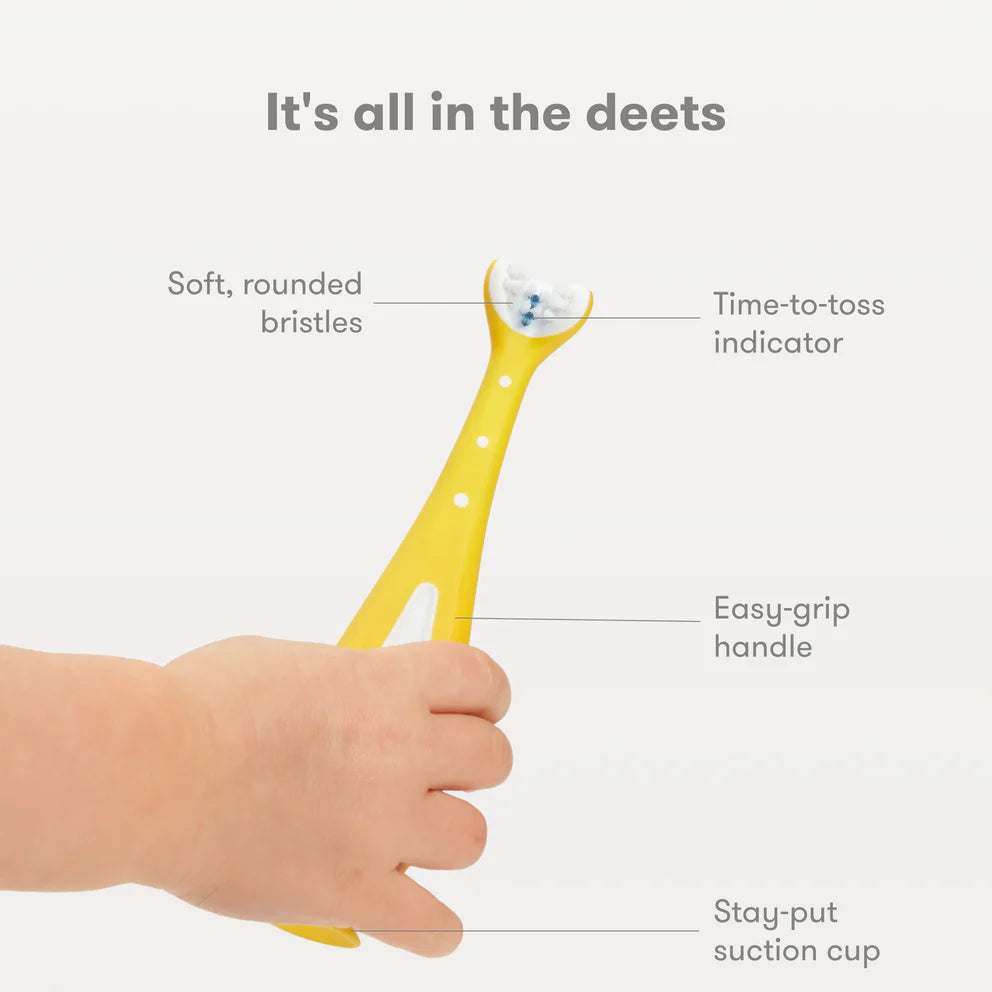 Frida Baby Training Toothbrush for Toddlers 18M+ with yellow easy-grip handle and soft rounded bristles