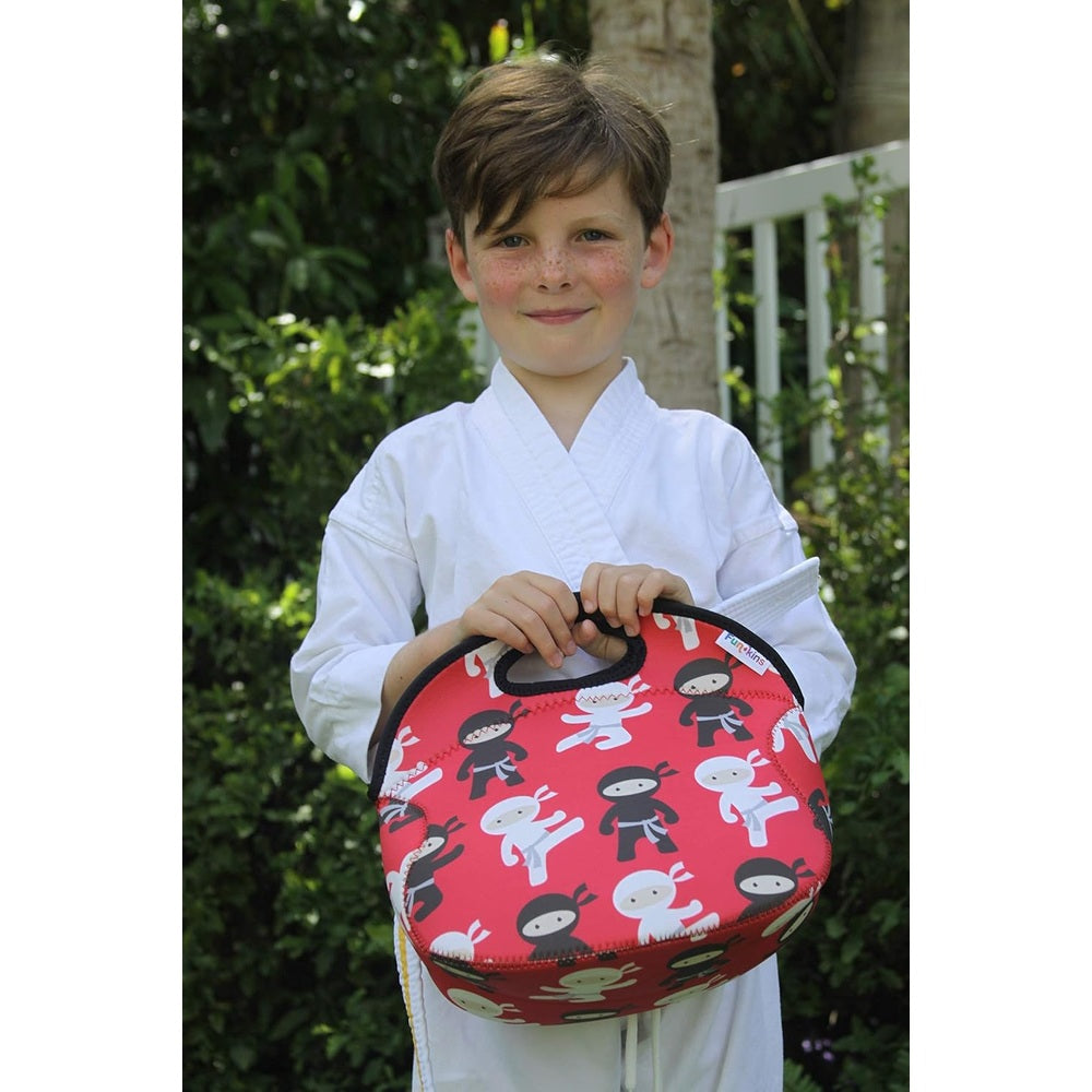 Red insulated lunch bag with black top handle and zipper, ninja-print featuring white and black ninjas.