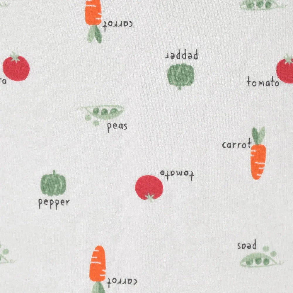 Gerber Baby Neutral Veggies Sleep N Play on soft white fabric with carrot, pea, tomato prints.