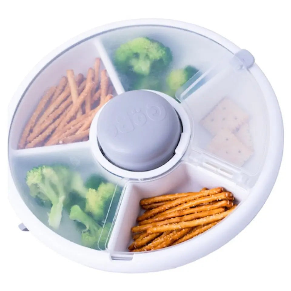 Gobe Snack Spinner Small round lunch box with four compartments, showing broccoli, crackers, pretzels neatly separated by dividers.