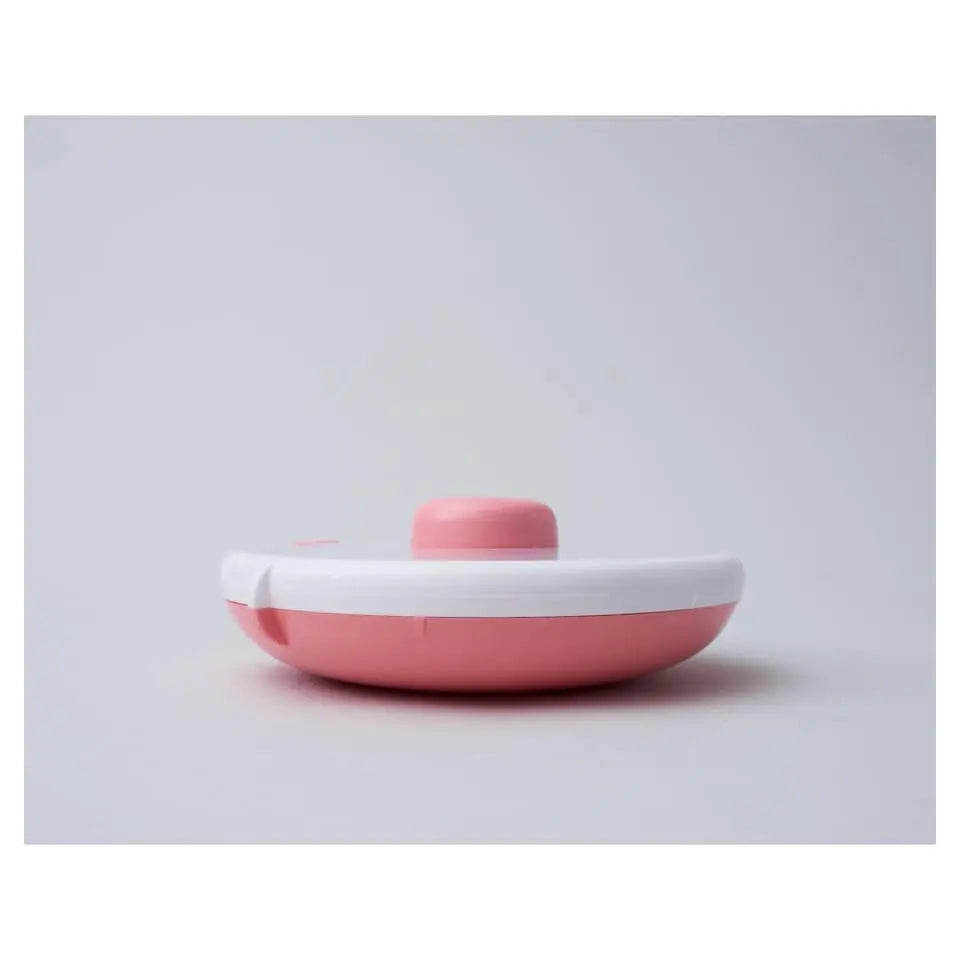 Gobe Snack Spinner Small pink and white lunch container with twist-on lid, resting on a clean surface.
