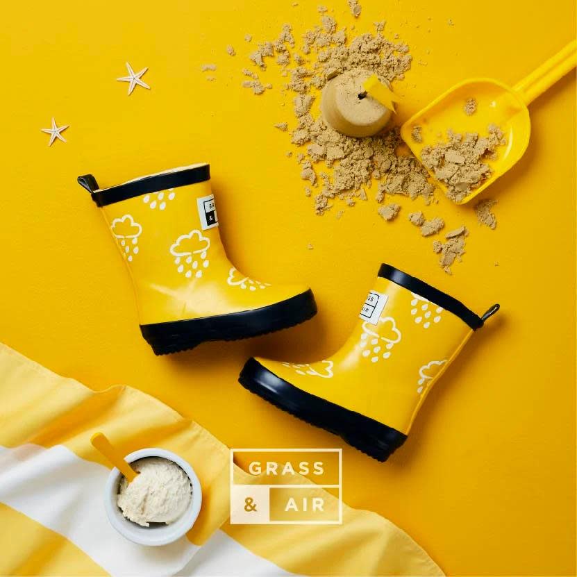 Grass & Air color-revealing kids rain boots, bright yellow with white cloud prints