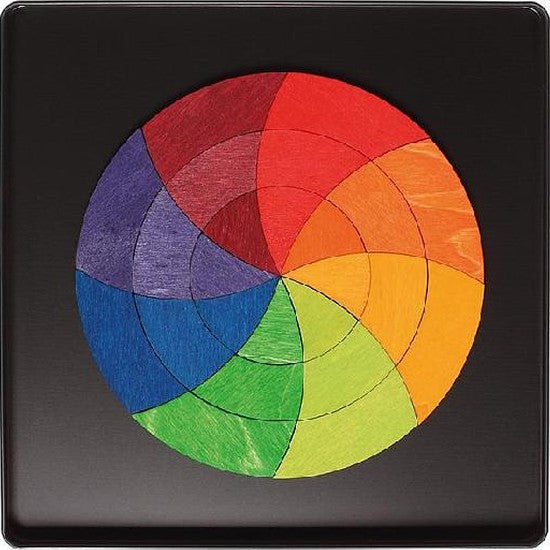 Grimm's Magnetic Puzzle in a black square tin with a multicolor circular segmented wheel.