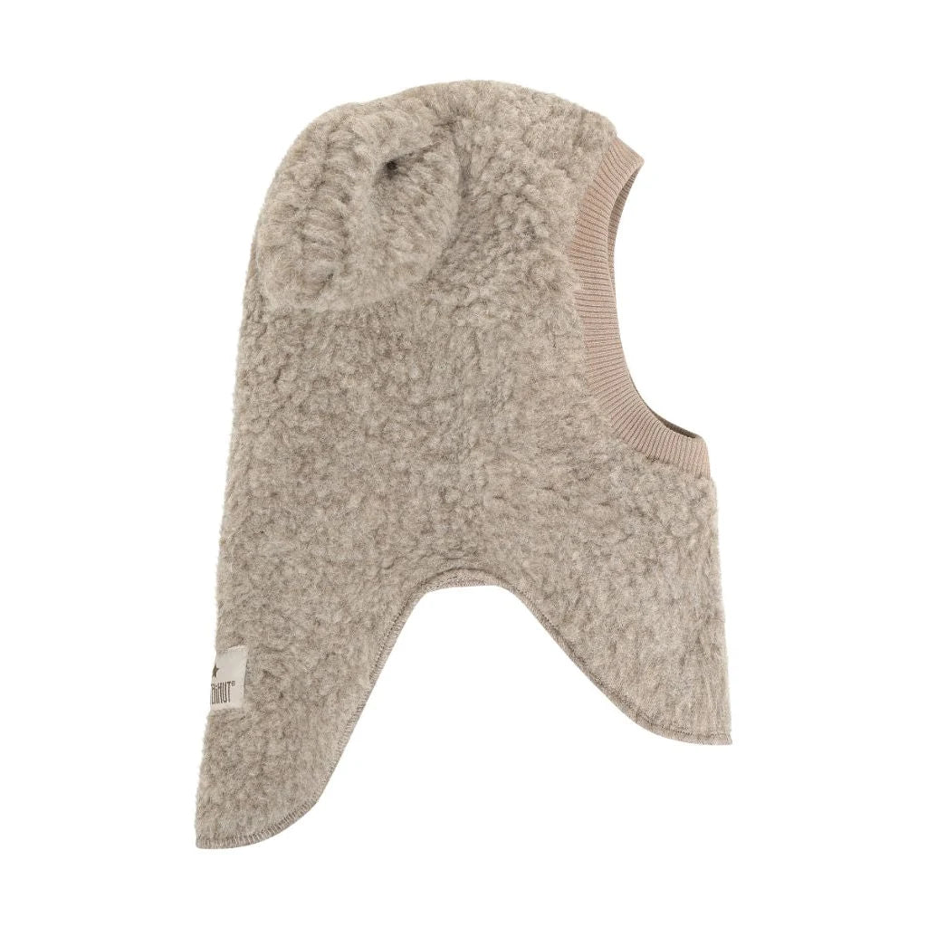 Side view of HUTTEliHUT Camel melange wool teddy balaclava showing the textured fabric and neck panels