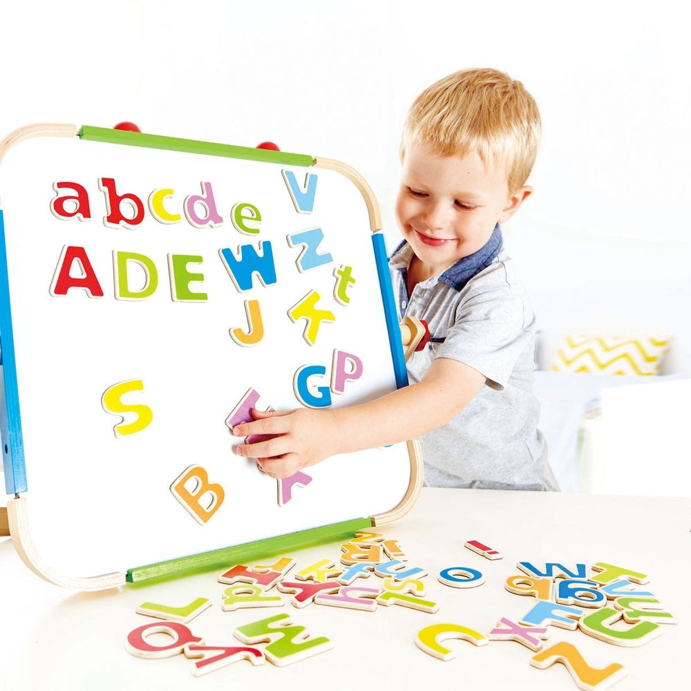 Hape ABC Magnetic Letters on a whiteboard; toddler arranges colorful alphabet letters during play.