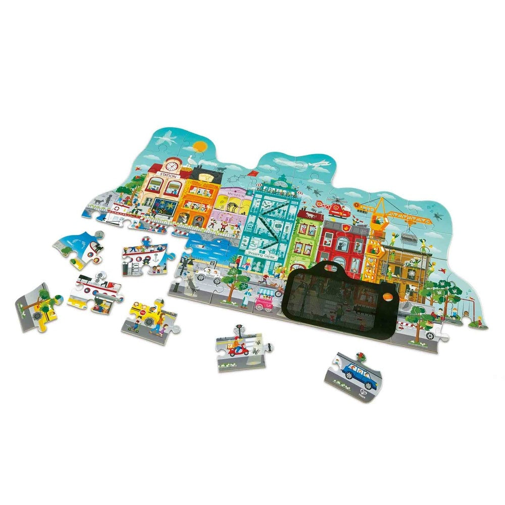 Hape Animated City Puzzle, colorful cityscape jigsaw with scattered pieces and a black storage tray