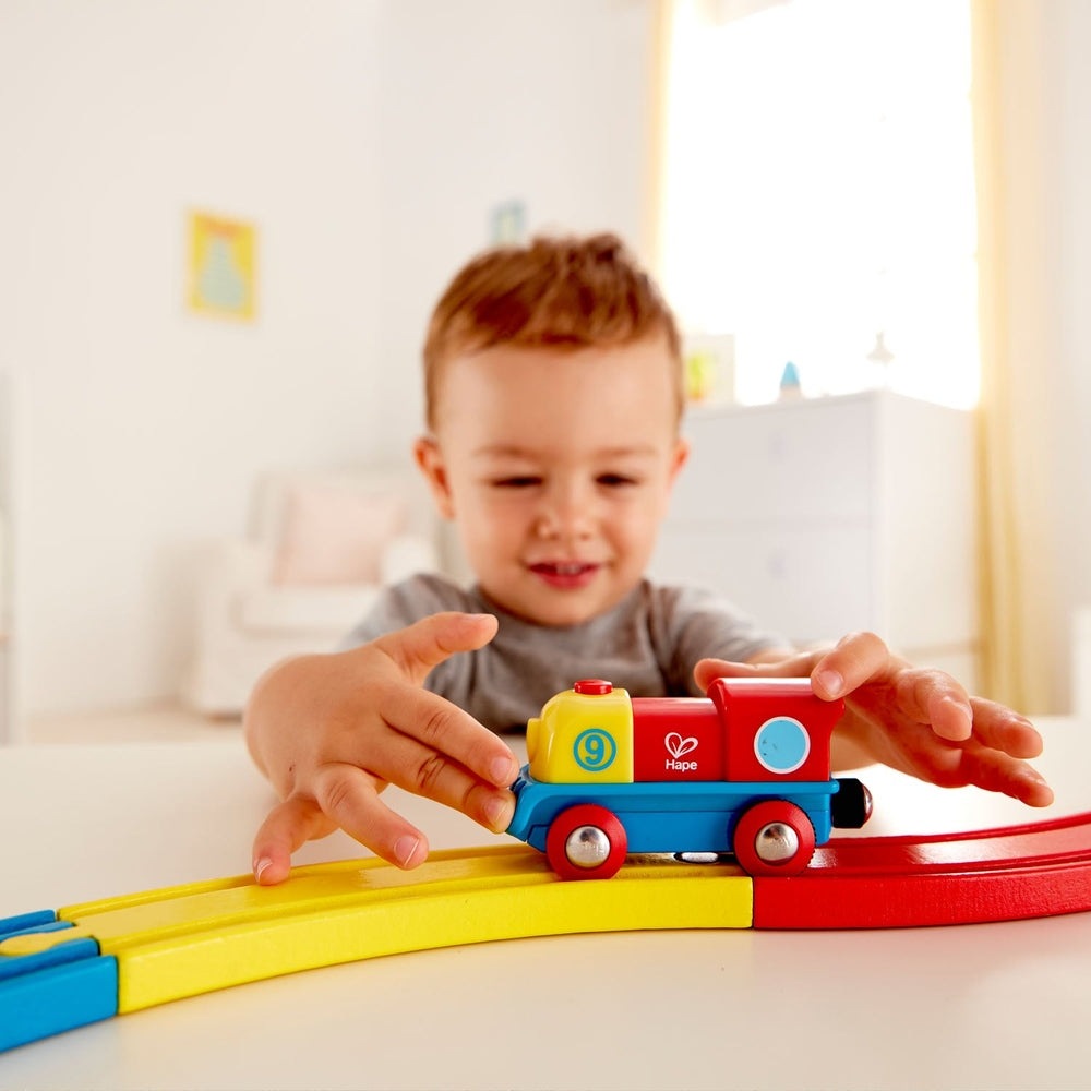 Hape Brave Little Engine wooden toy train, 3-car set in yellow, red and blue on curved track