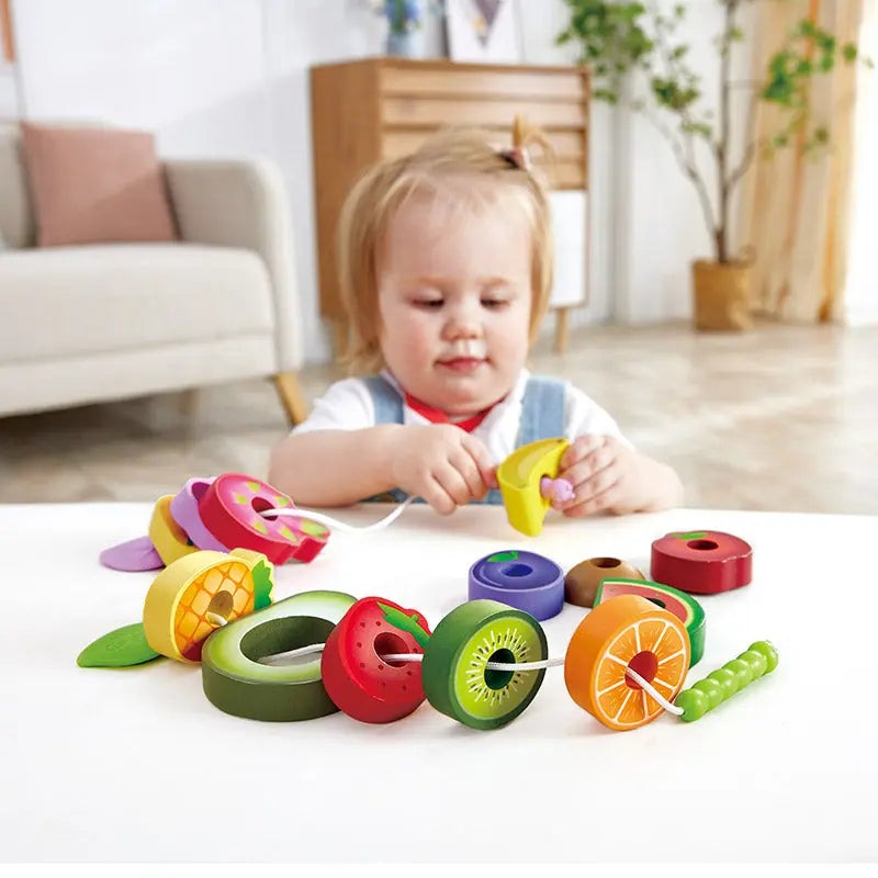 Hape Caterpillar Fruit Feast Set; colorful plastic fruit beads and rings on string for toddlers