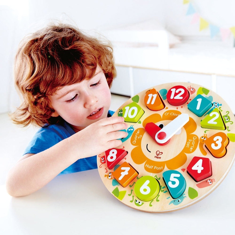 Hape Chunky Clock Puzzle, wooden colorful numbers with movable hands; child places pieces around clock.