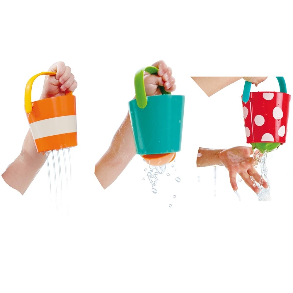 Hape Happy Buckets Set: three colorful bath buckets being used to pour water, orange-striped, teal, and red polka-dot.