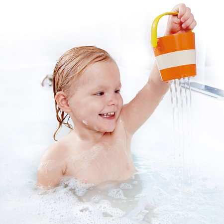 Hape Happy Buckets Set: toddler in bath holds an orange striped bucket with a yellow handle.