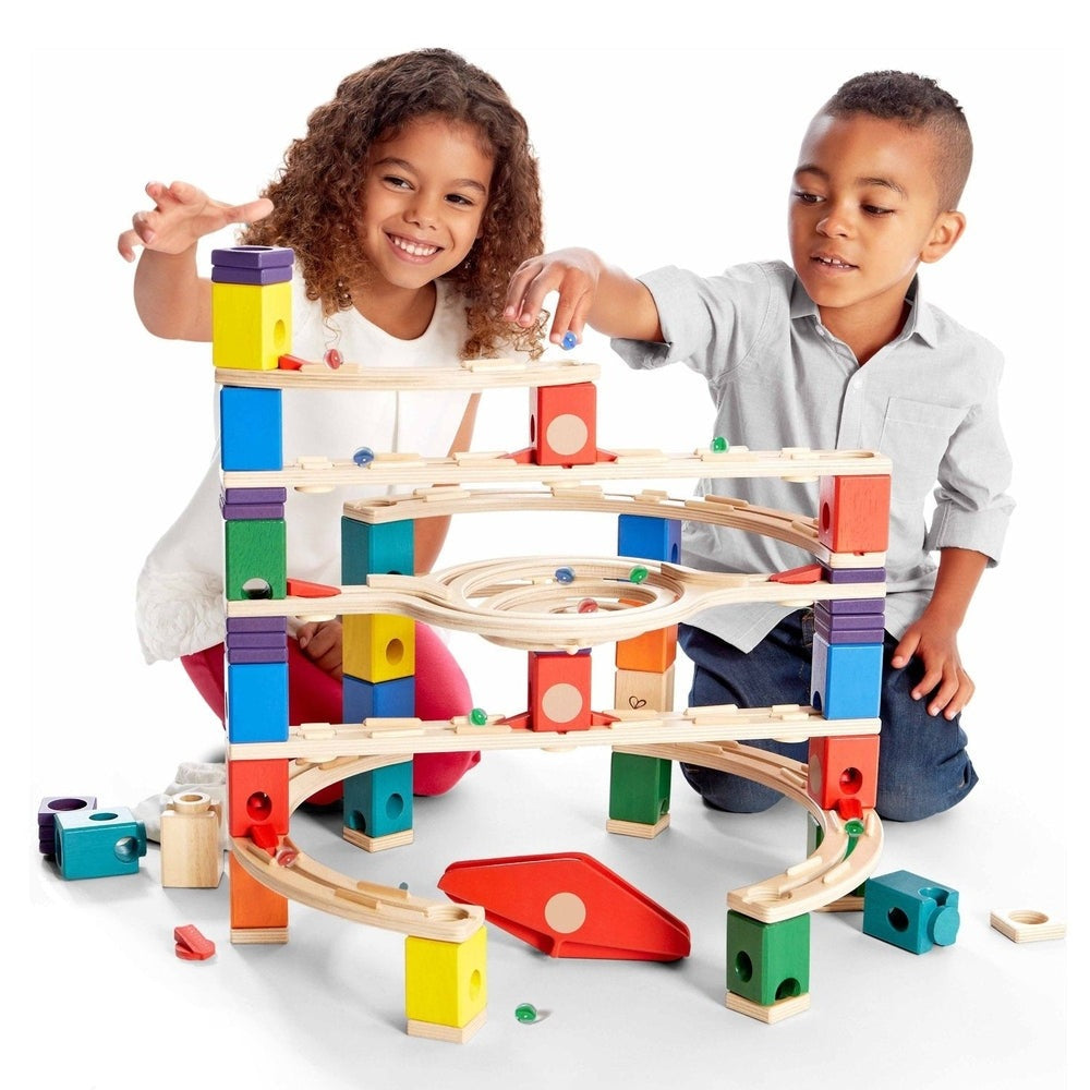 Hape Loop De Loop marble run toy, wooden with colorful blocks, kids actively building and guiding marbles.