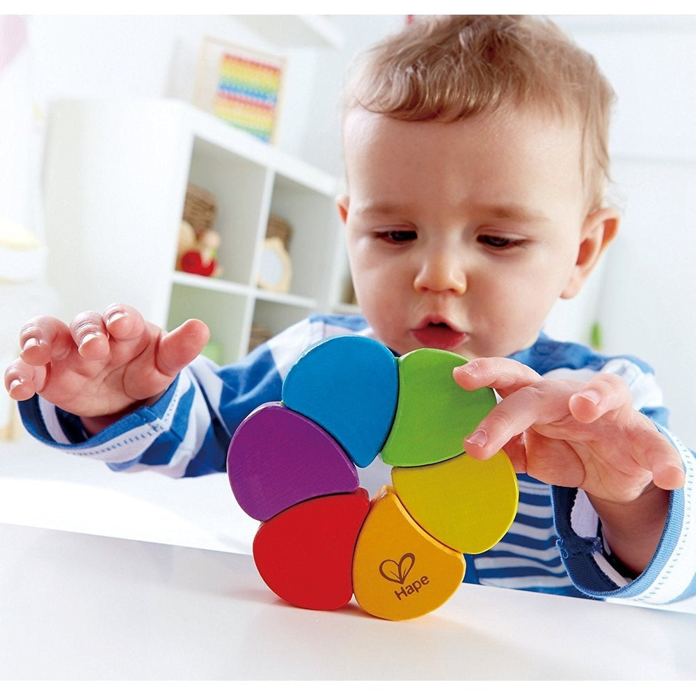 Hape Rainbow Rattle flower toy with bright rainbow petals and yellow center