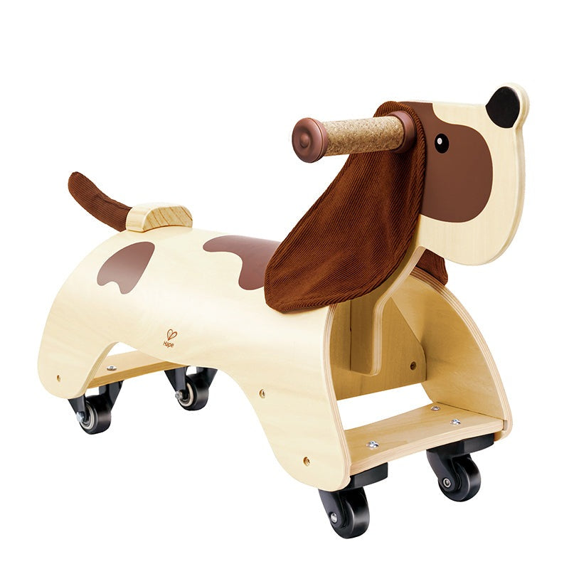 Hape Ride-On Dachshund wooden riding toy with brown fabric saddle and cork handlebar on wheels