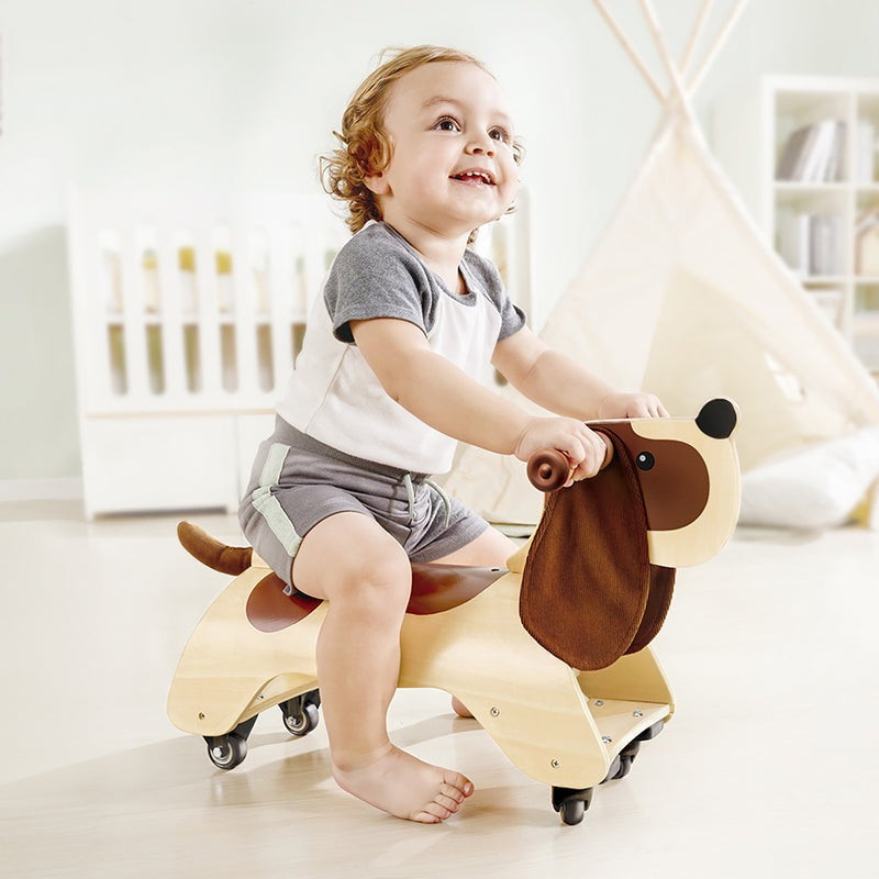 Hape Ride-On Dachshund wooden riding toy for toddlers with a natural wood finish