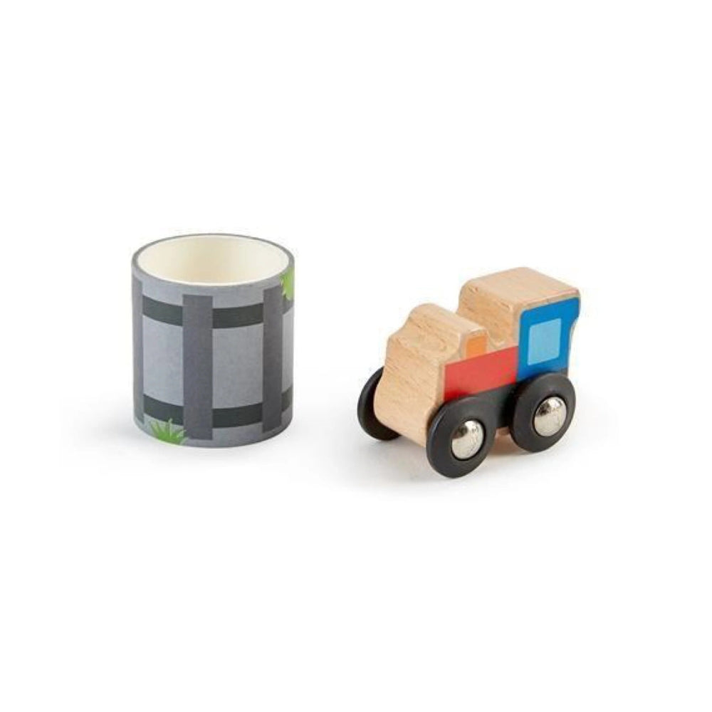 Hape Tape & Roll Train wooden toy with colorful blocks on a black-wheeled car beside a gray barrel.