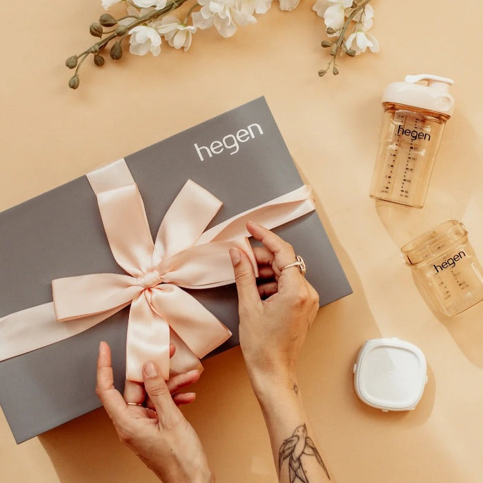 Hegen Essentials Starter Kit gift box with pink satin ribbon and two HEGEN baby bottles