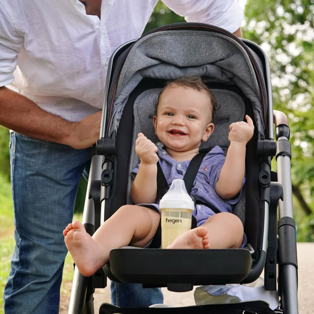 Hegen PCTO Express Store Feed Starter Kit bottle set; smiling baby in stroller with a HEGEN bottle.