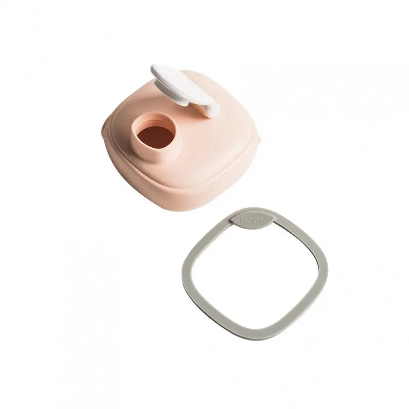 HEGEN PCTO Spout with gray ring accessory beside a pink silicone bottle base, for transitions.
