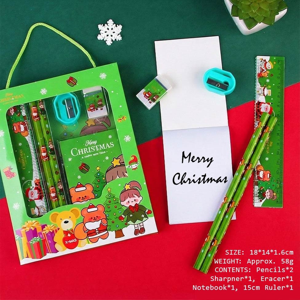 Holiday Joy Kids Stationery Gift Pack by baby enRoute, green festive box with handle showing pencils, sharpener, eraser, notebook, ruler.