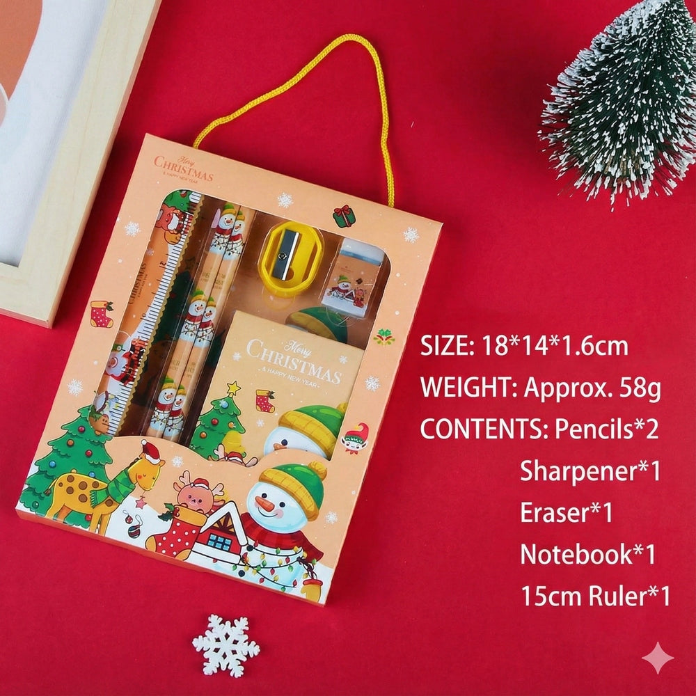 Holiday Joy Kids Stationery Gift Pack by baby enRoute, open to reveal Christmas pencils, notebook, ruler, sharpener, eraser.