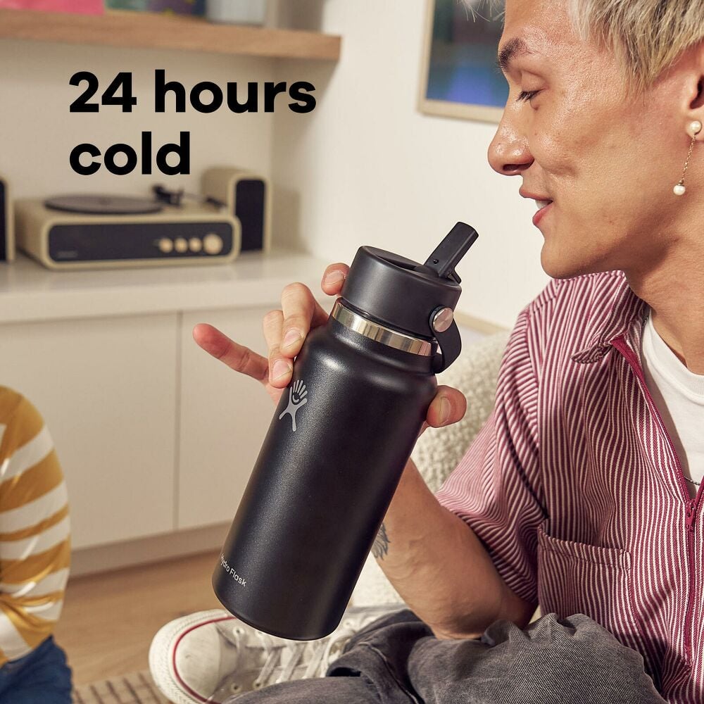 Hydro Flask 32 oz Wide Mouth Bottle With Flex Straw Cap – Man sitting in living room holding a 32 oz hydro flask with text overlay stating 24 hours cold