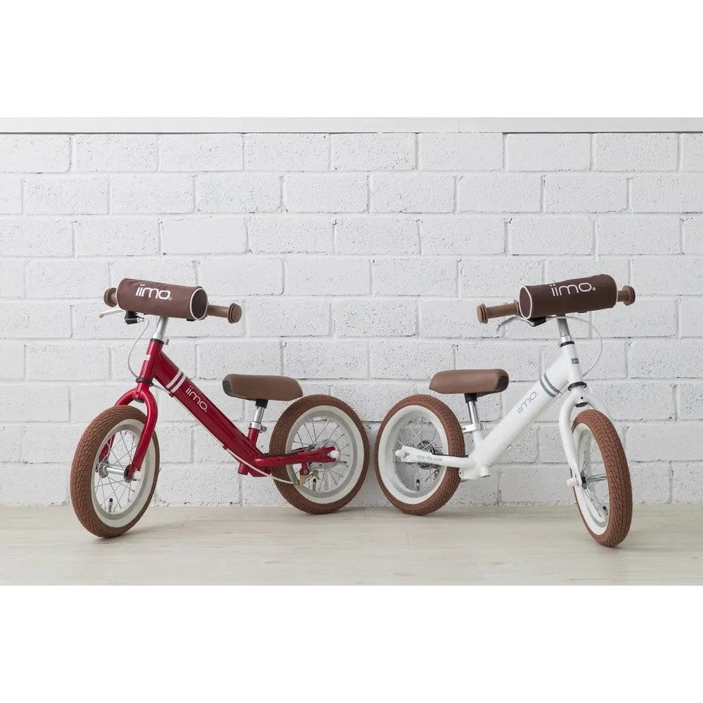 Iimo Balance Bike pair in red and white with brown saddles and tires, standing side by side.