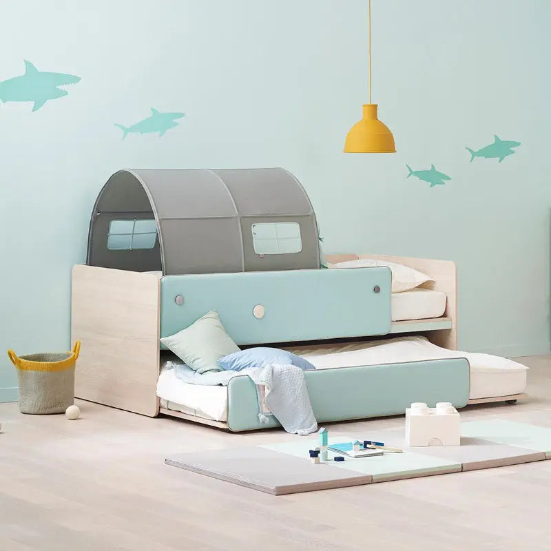 ILOOM Cabin 2-Story Sliding Bed in light blue upholstery with gray canopy, top bunk folded back over lower bed.