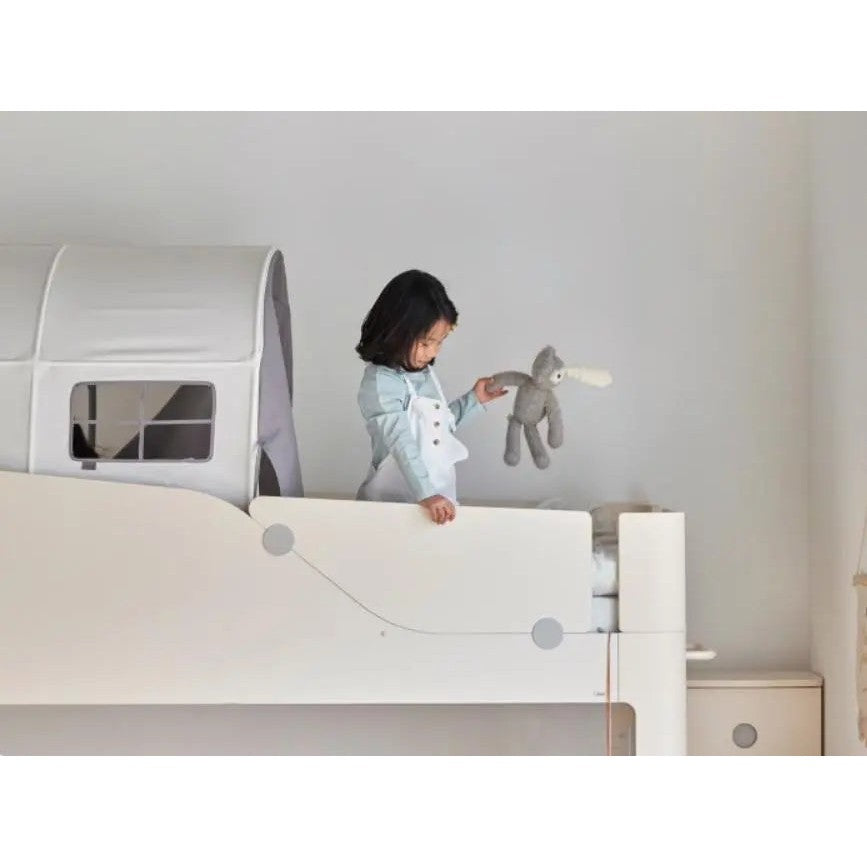 Iloom Cabin Kids Tent, white bunk-bed nook; girl on the loft holds a grey plush rabbit beside the tent.