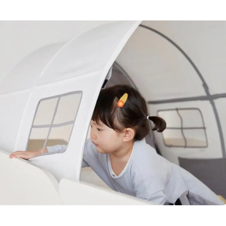 Iloom Cabin Kids Tent by ILOOM, white fabric play tent with windows; child crawls through the doorway.