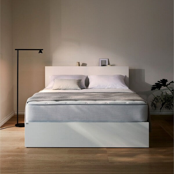 Iloom Daily Light Firm Mattress K size on white bed frame in a minimalist bedroom with a floor lamp