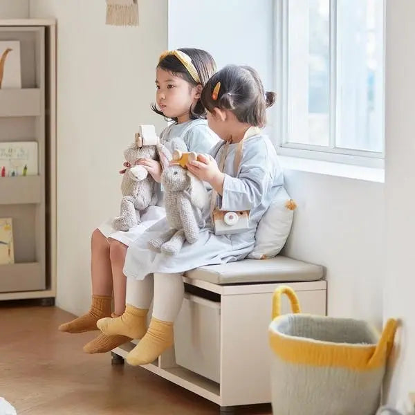 Iloom Eddi Kids Bench 950W with white finish and under-seat storage; two kids sit, holding plush toys.