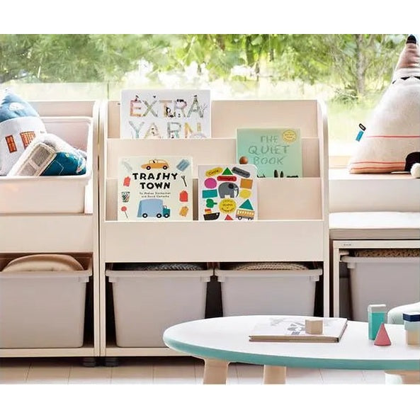 Iloom Eddi Kids Bookshelf white with storage bins holding colorful books in a cozy reading nook.