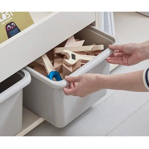 ILOOM Eddi Kids Bookshelf white with pull-out storage bin in use holding wooden blocks.