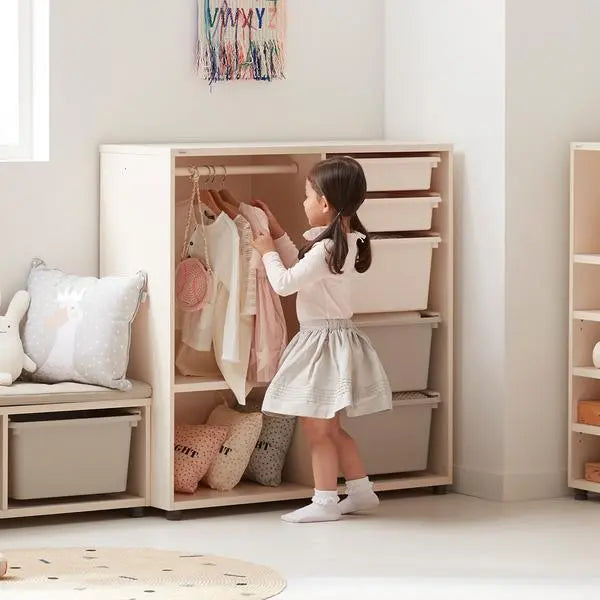 Iloom Eddi Kids Daily Wardrobe white cabinet with hanging rod and 4 drawers; girl arranging clothes.