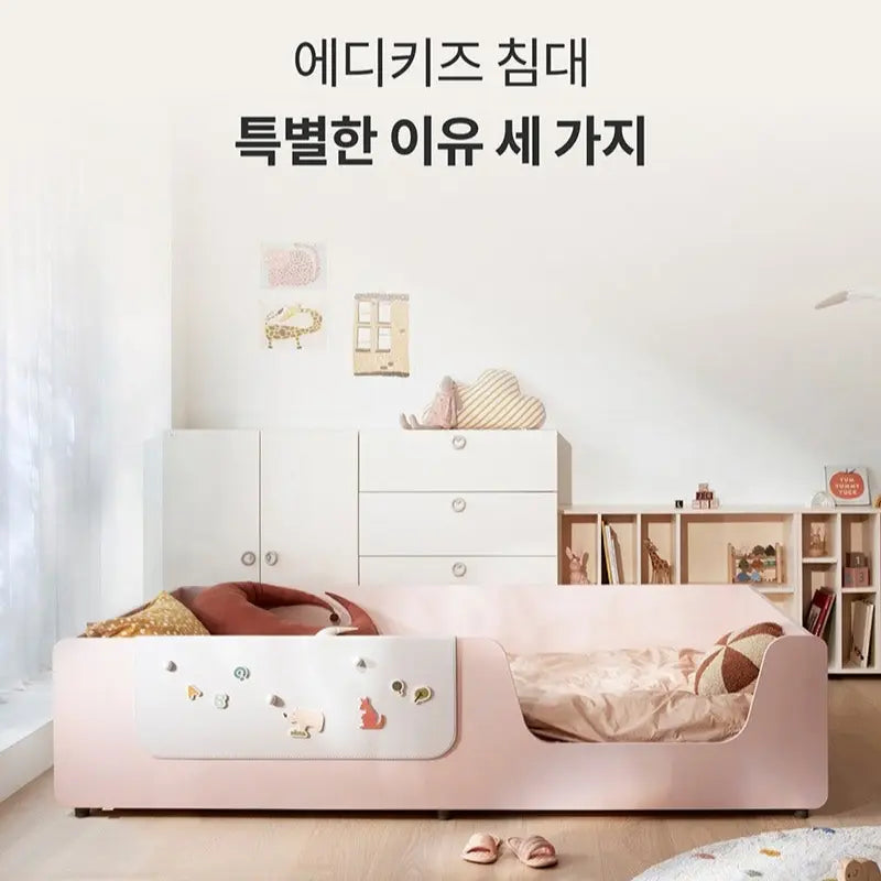 Iloom Eddi Kids Low Bed 1100W pale pink with curved sides and built-in storage, shown beside open shelves.