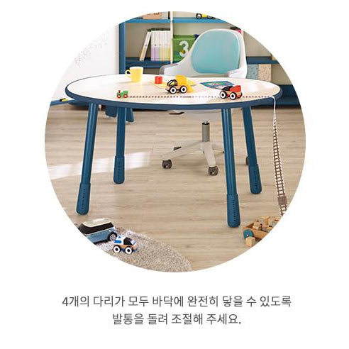 ILoom Growing Desk Peanut 1200W, round white table with blue legs, kids’ toys on desk ready for learning.