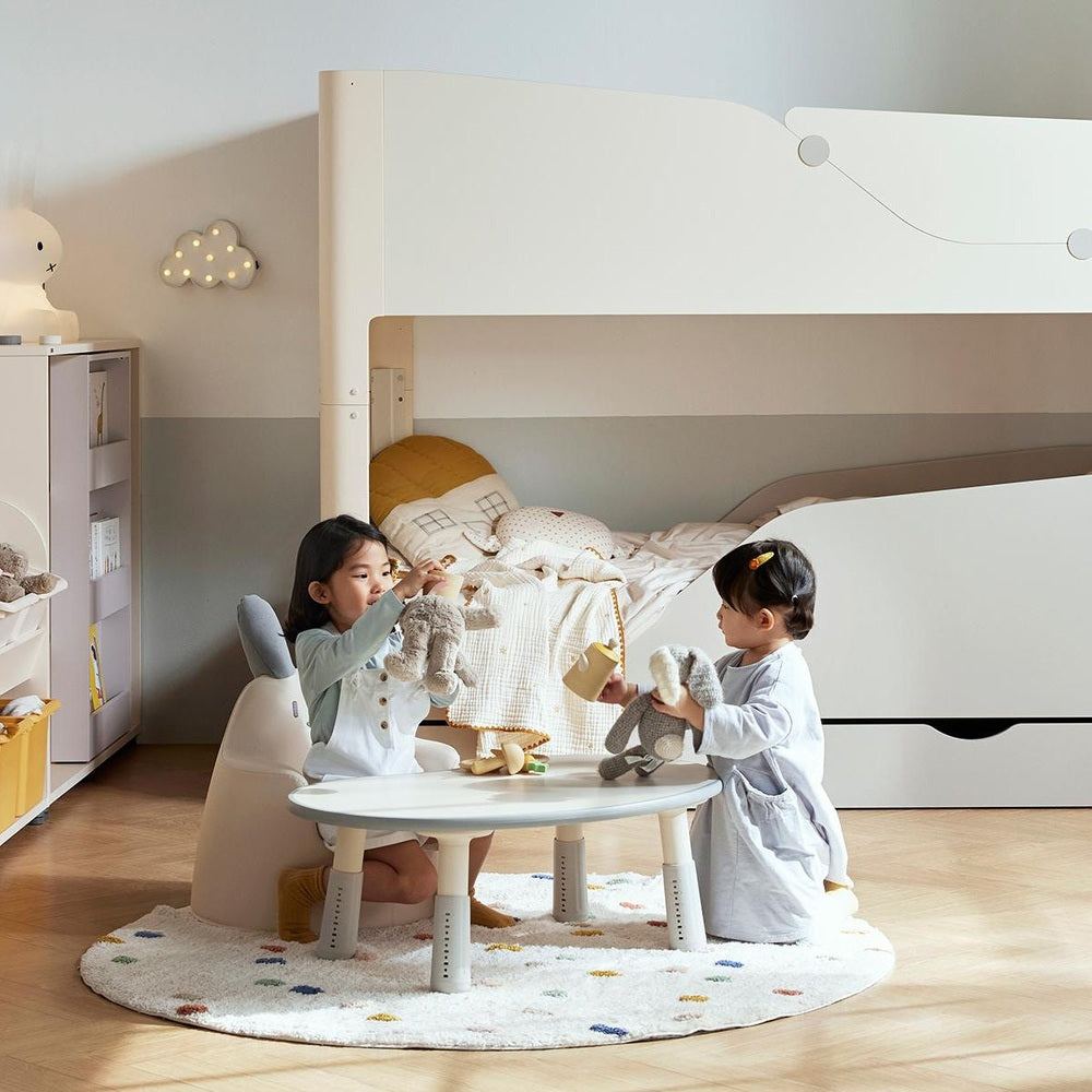 ILOOM Growing Desk Peanut 800W activity table in white with pale wood legs, kids playing.