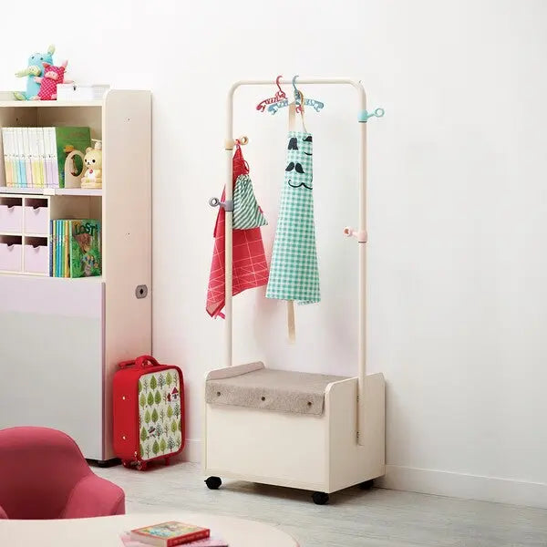 Iloom Linki Plus Moving Hanger in white frame on wheels; red and teal gingham fabrics hung in a bright kids' room.