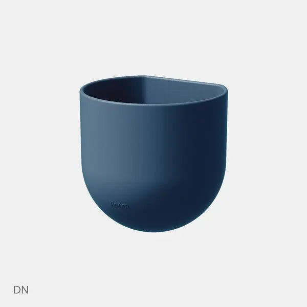 Iloom Linki Plus Multipurpose Pencil Holder in dark blue silicone, keeping pens upright on a clean desk.